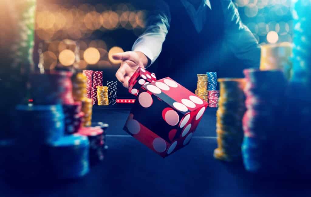 A man immerses himself in the thrill of the craps table at a bustling casino.