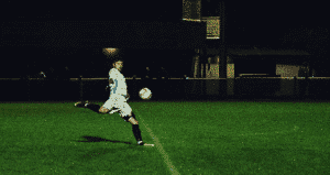 A Soccer Enthusiast Strikes the Ball with a Volley