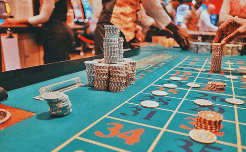 A roulette table bustling with high-stakes players