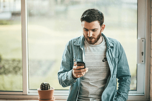 Man placing live bets on his phone
